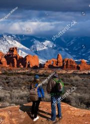 stock-photo-couple-enjoying-beautiful-mountain-view-on-hiking-trip-in-utah-the-windows-section-of-the-park-2280962311